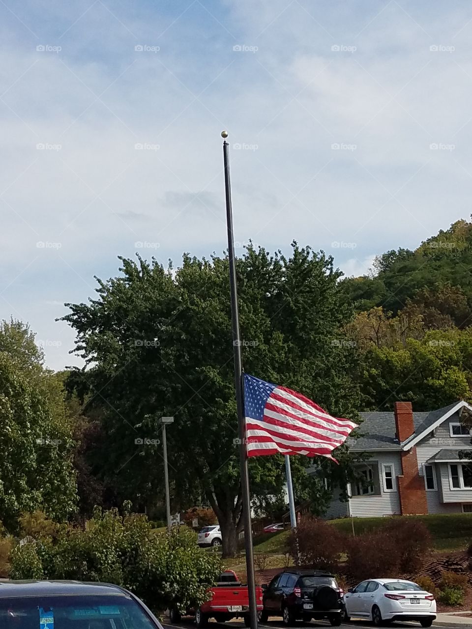 The American flag flying at half mass after shootings in another state.