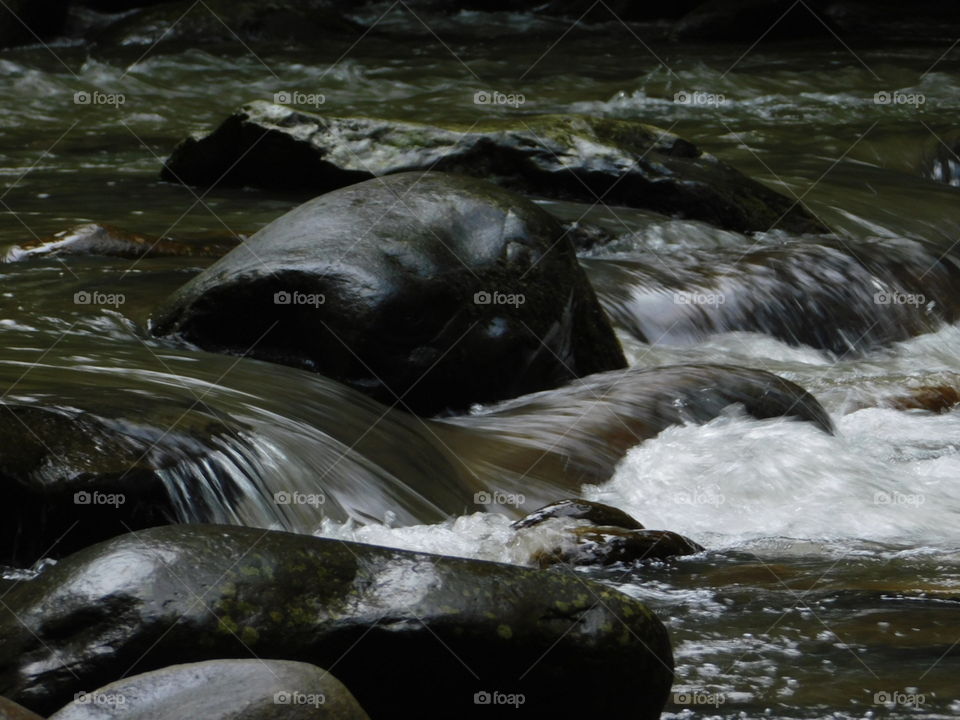 flowing river over stones