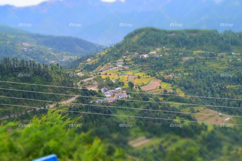 valley. Bird view of a small settlement in the foothills of a hill station amidst the greenery and terrace farming