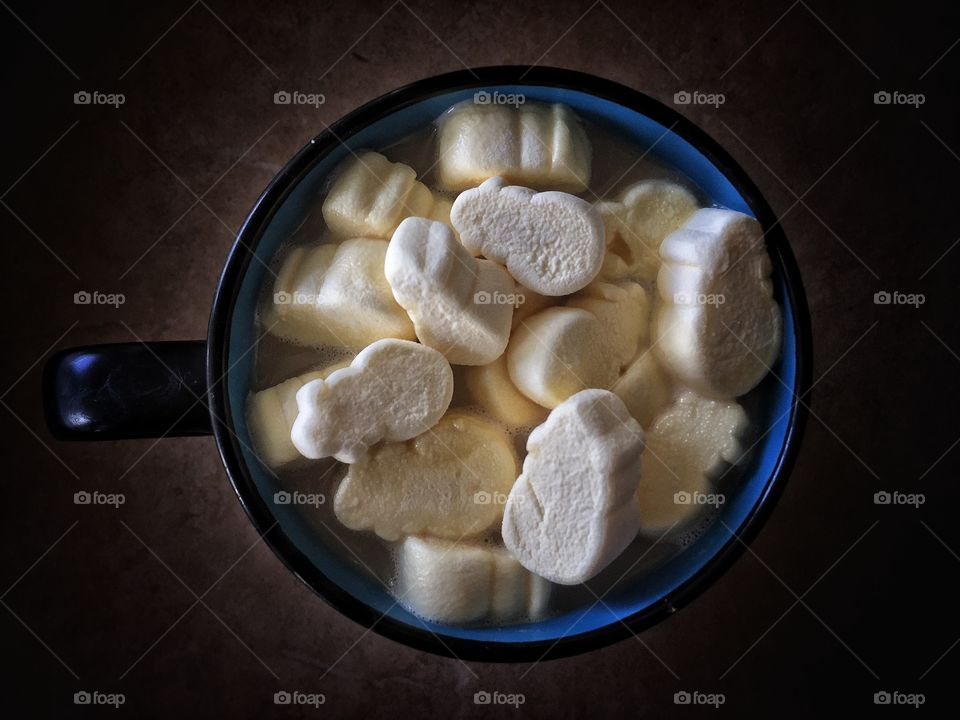 Hot coffee and milk with marshmallows as snow man