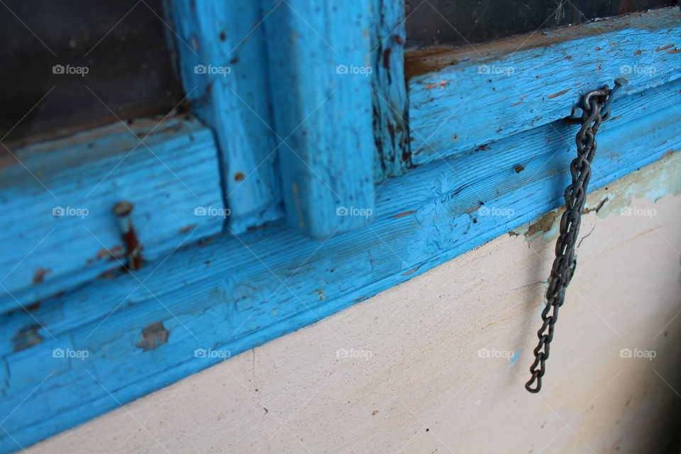 blue old wood and a rusted chain