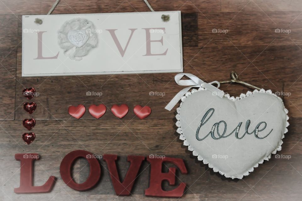 The word LOVE written in various trinkets with love  hearts
