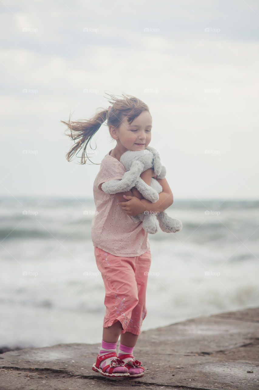 Girl portrait near sea a windy day