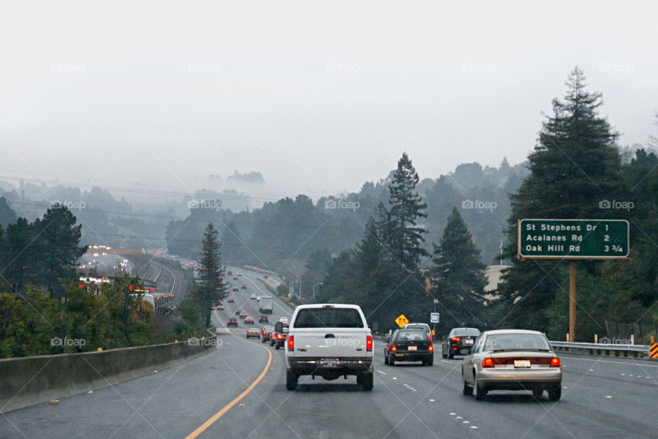 Cars on a freeway. Foggy weather 