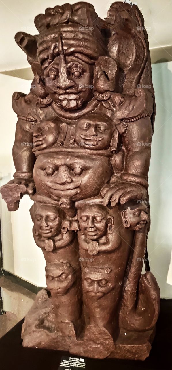 an ancient statue of kirtimukha. Kirtimukha is the name of a swallowing fierce monster face with huge fangs, and gaping mouth, very common in the iconography of Hindu temple architecture and Buddhist architecture in South Asia and Southeast Asia.