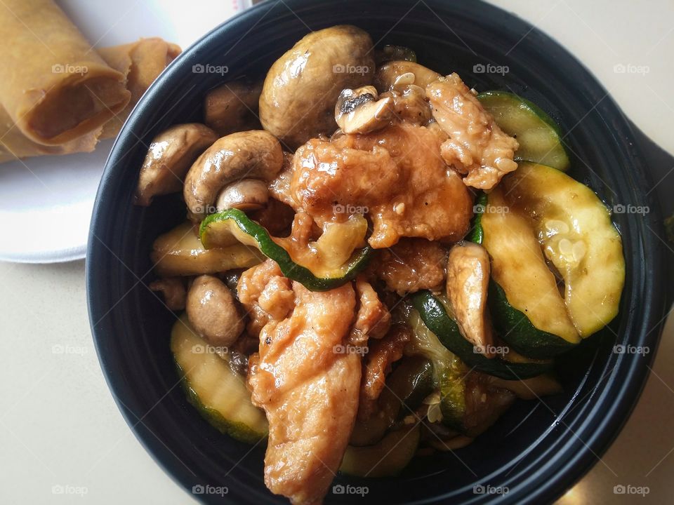 Mushroom chicken with zucchini and a side of spring rolls