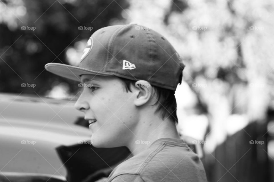 Side view of a boy wearing cap