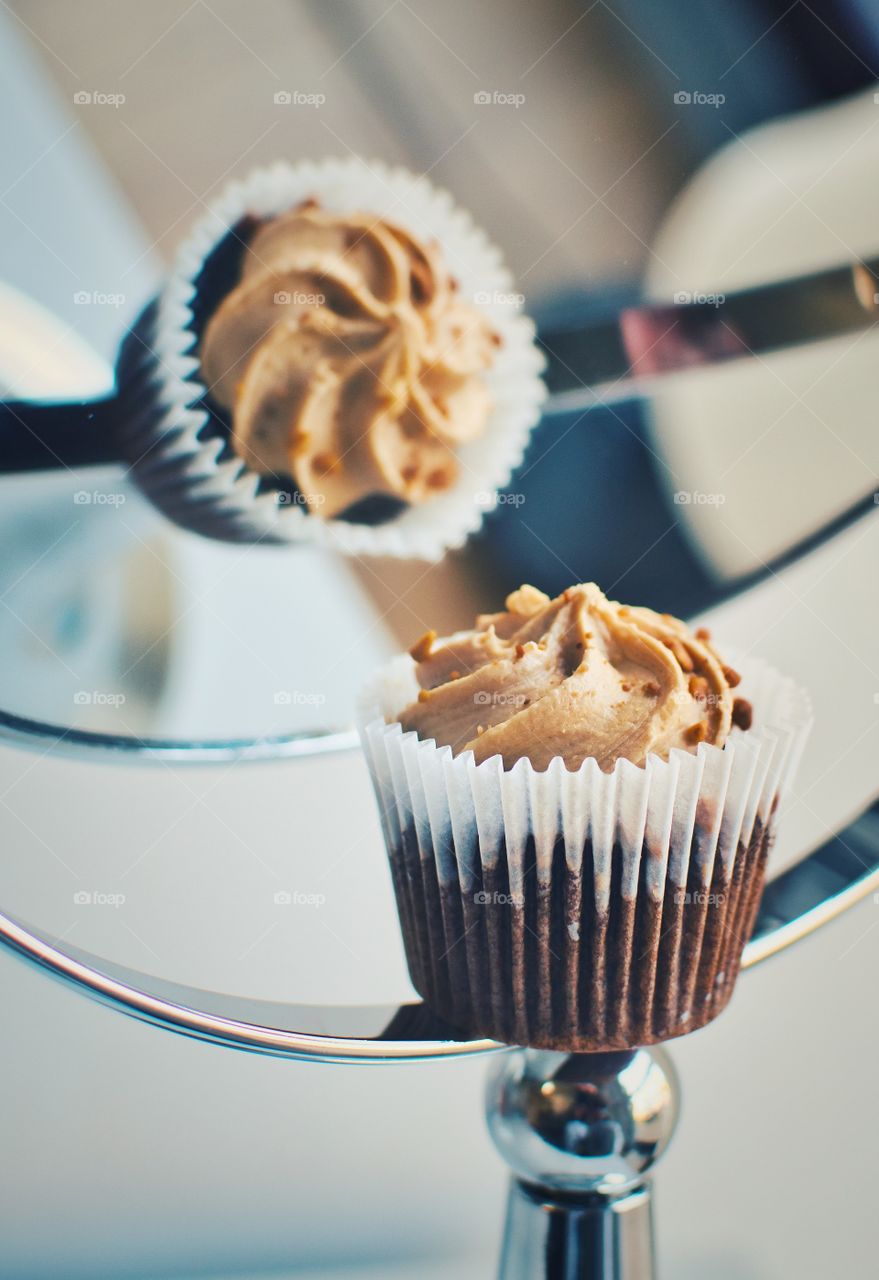 Chocolate cupcake with caramel filling reflected in the mirror