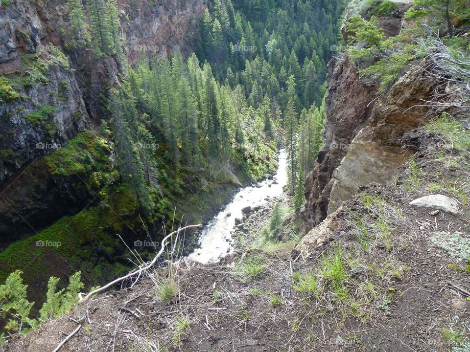 Water travels down a steep valley gap.