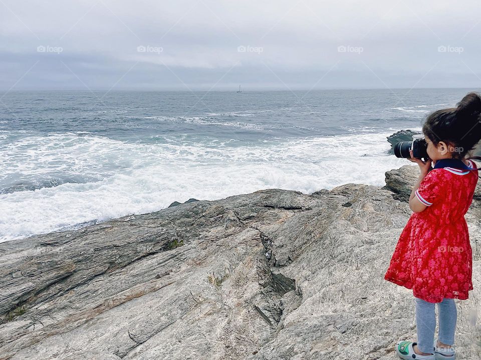 Little girl photographs coastline, toddlers with cameras, taking pictures in Rhode Island, vacationing on the coast 