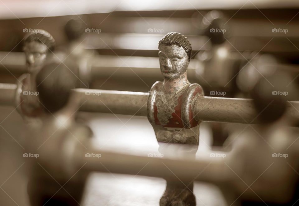 Close up of an old football table player, with peeling paint