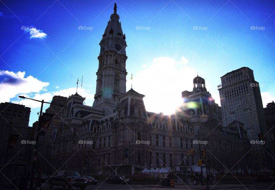 Sunrise over the Philadelphia city hall building and clock tower with a blue sky