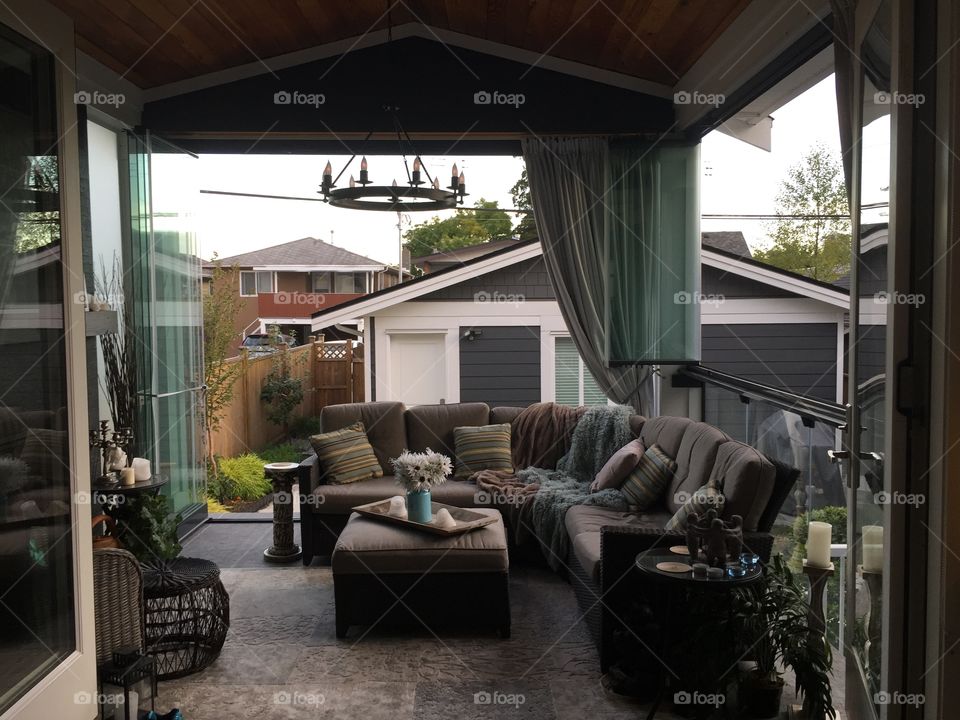 Oasis within the urban environment, consisting of faux fur throws, curtains, candles and a fireplace