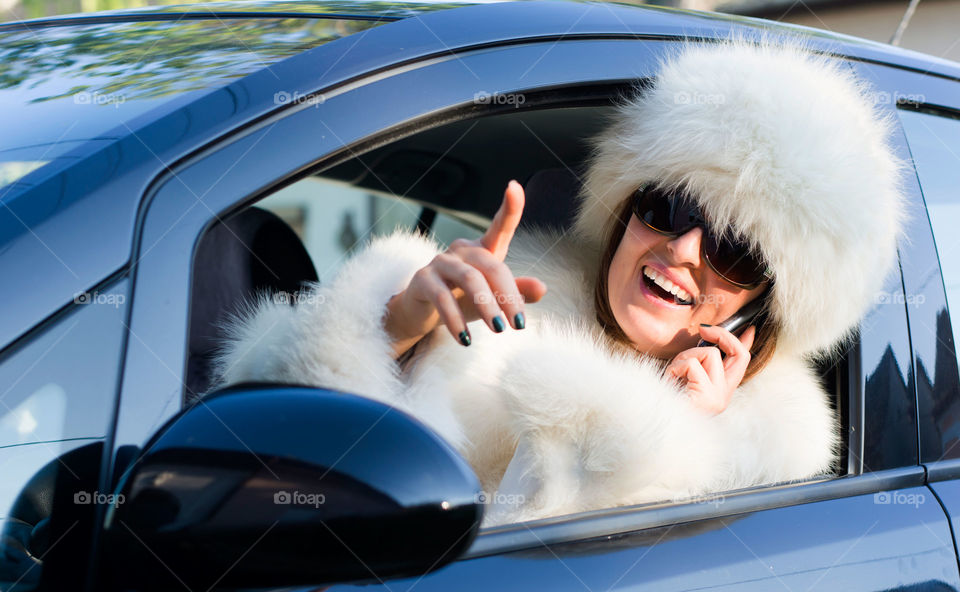 woman multitasking. woman driving and talking on the phone