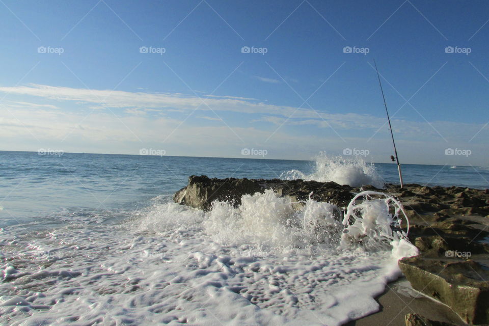 Beach fishing . Fishing on the beach as waves crash on a coral reef. Singer island, Florida 