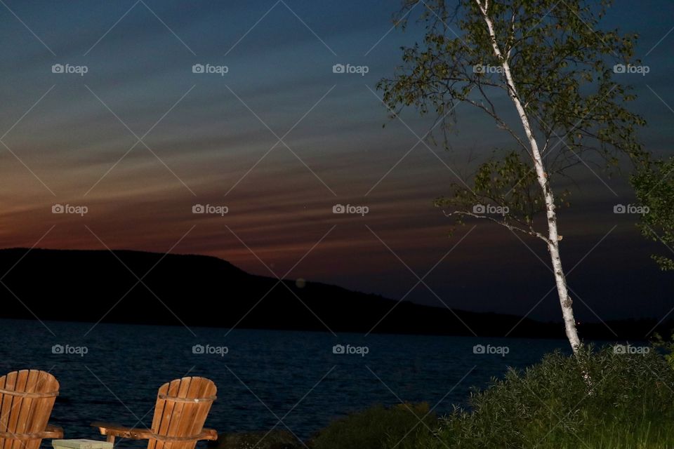 Adirondack chairs by He lake in the Adirondack mountains northern New York State lakes region 