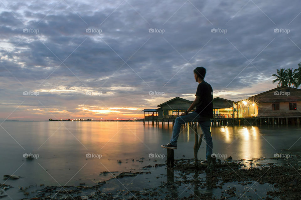 Man standing againts Sunset Landscape