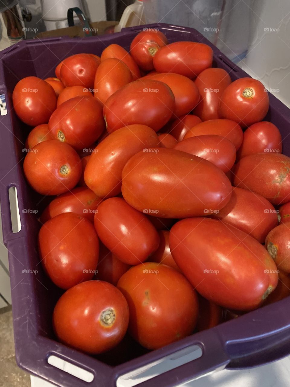 Roma tomatoes in a crate.