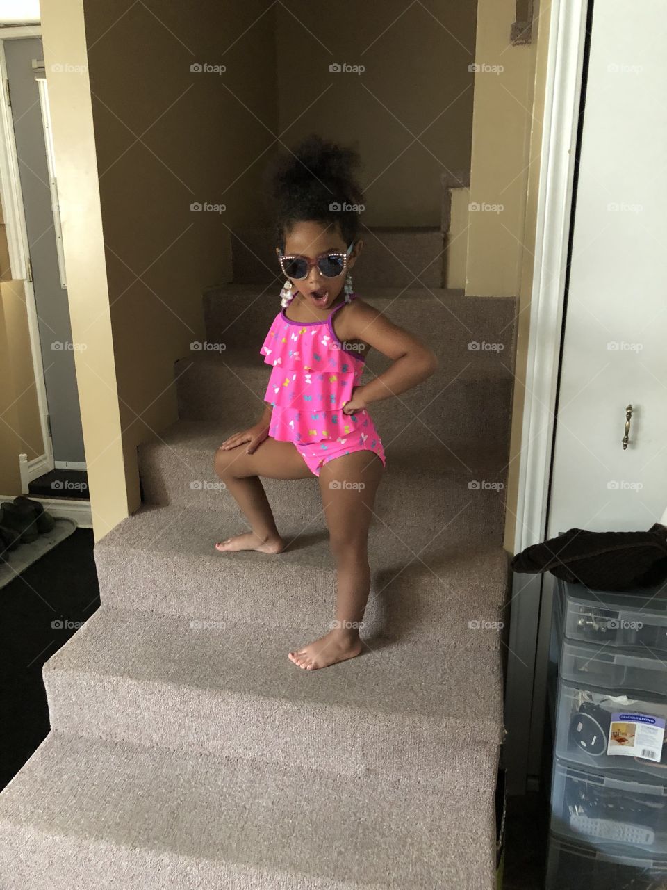Little girl in a bathing suit with sunglasses 