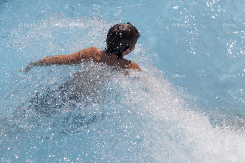 Kid swimming in the pool