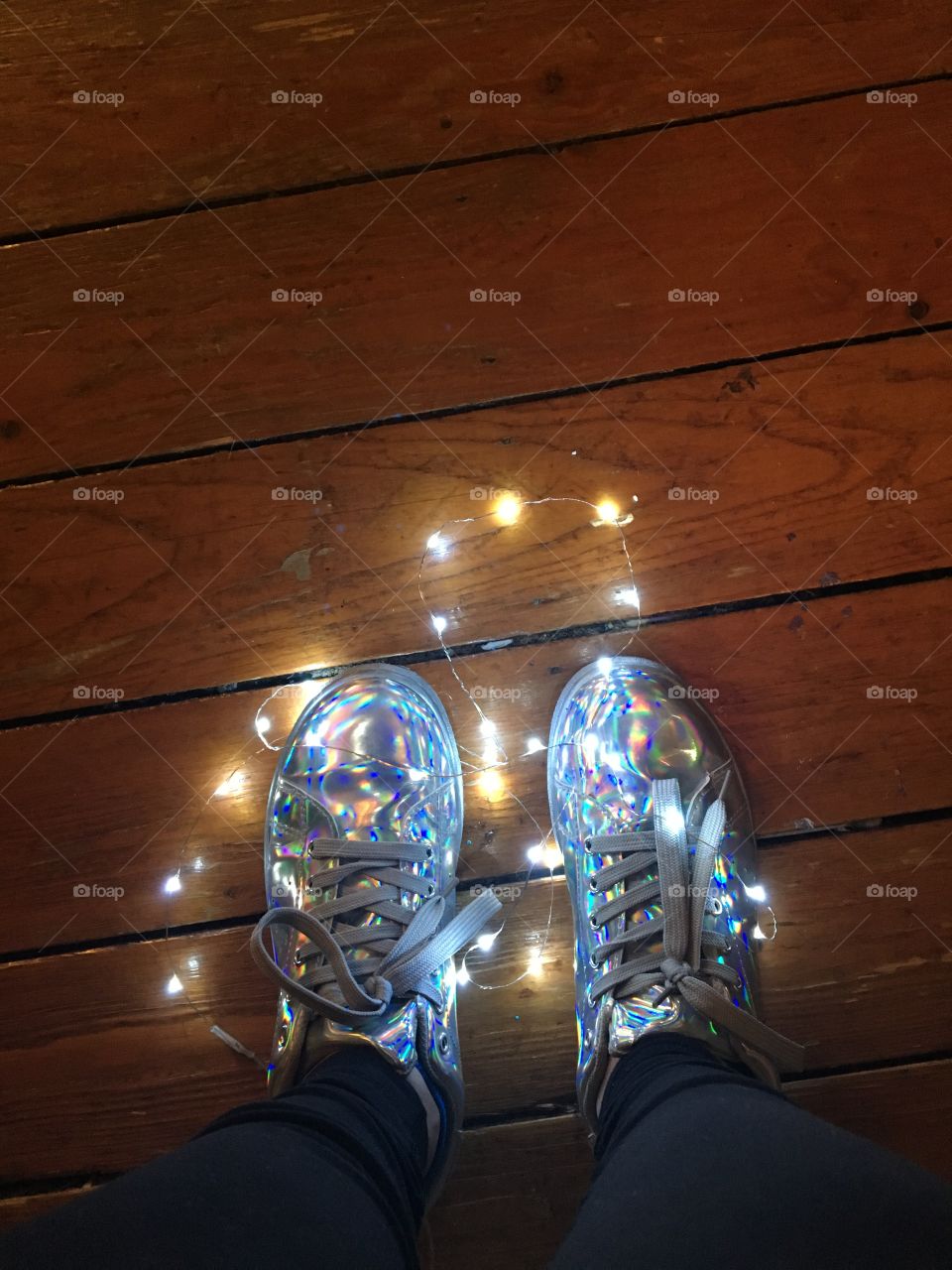 Fairy lights around holographic shoes. 