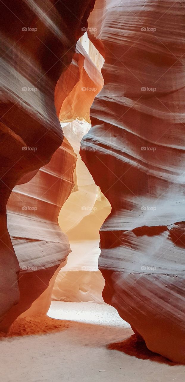 Inside the Antelope Slot Canyon in Arizona,  showing the swirling formations caused by water rushing through the narrow canyon.