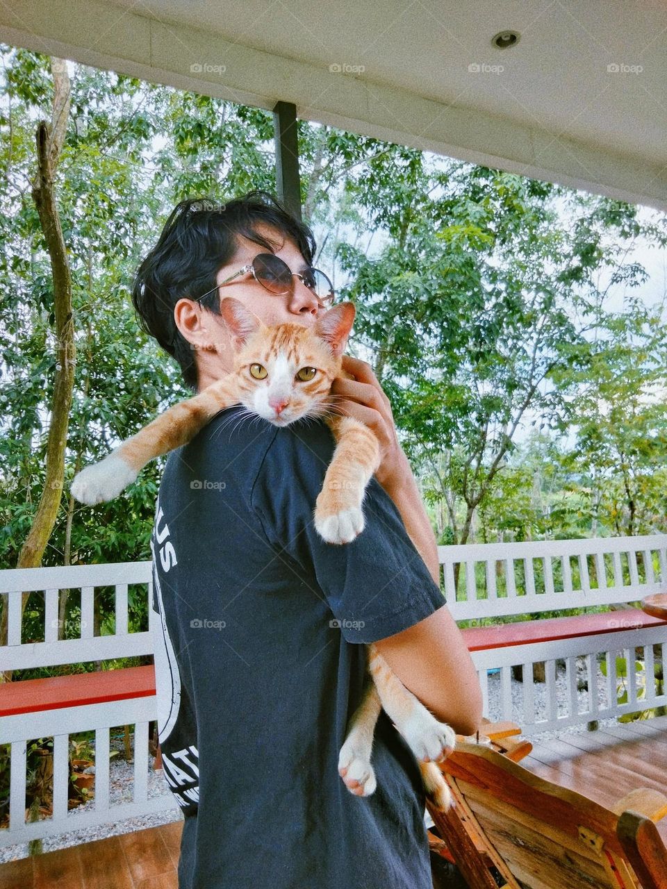 My boyfriend is holding an orange cat. Do you see this cat's expression?