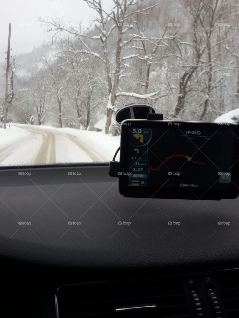 Winter snow road & navigation. view from the car