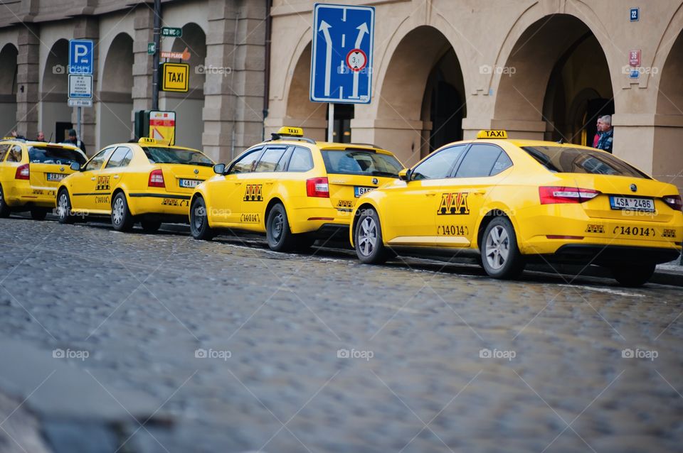 taxi drivers stand in the parking lot waiting for passengers