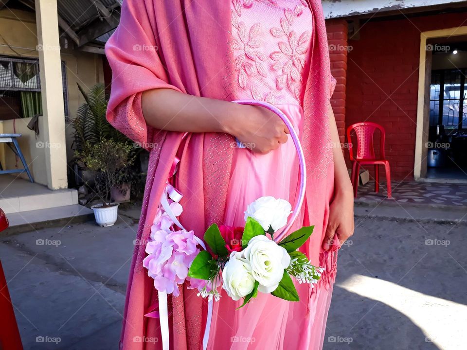 A bridesmaid with flower bouquet