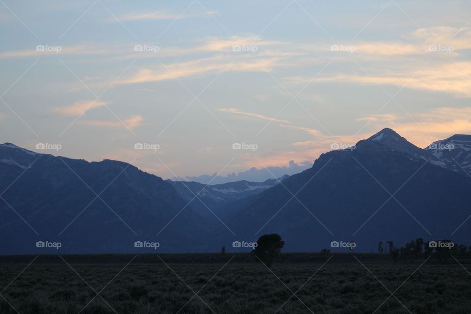 Sunset silhouette colorful field prairie tree clouds cloudy mountain mountains view scenic outdoors