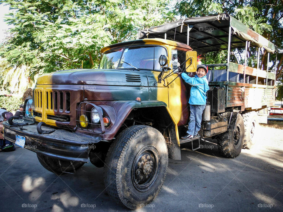 Happy boy is going to a trip on a truck