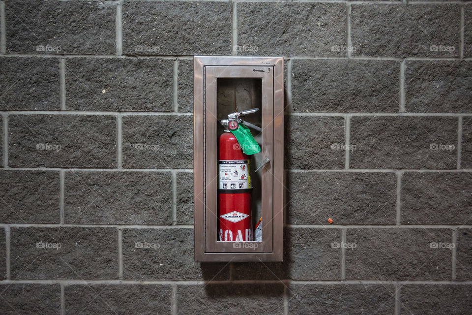 Portable fire extinguisher on the wall