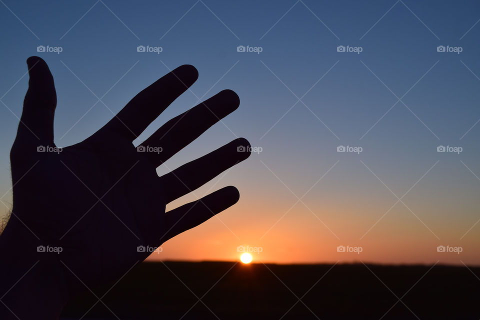 Silhouette of hand during sunset