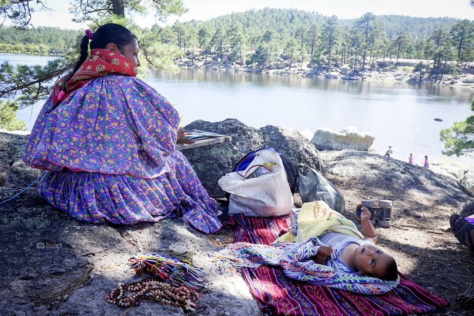 Tarahumara lady working in front of the lake. Tarahumara people don’t like to be photographed but I asked her and she said yes, even though she looks like she did not enjoy it at all. 