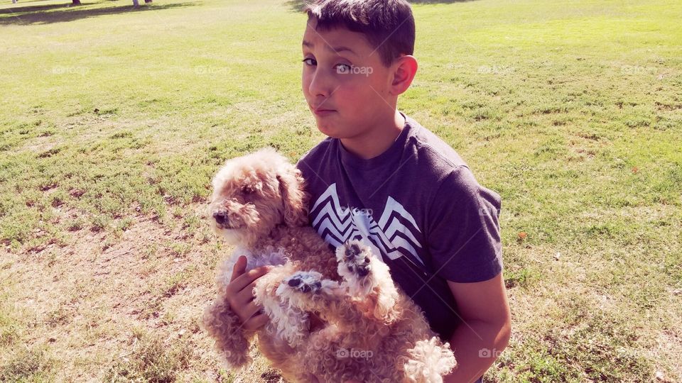 playing in the park with his dog