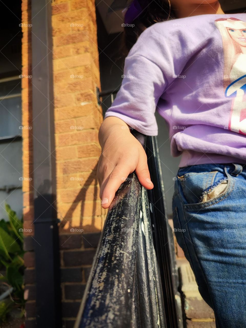Child's hand on railing