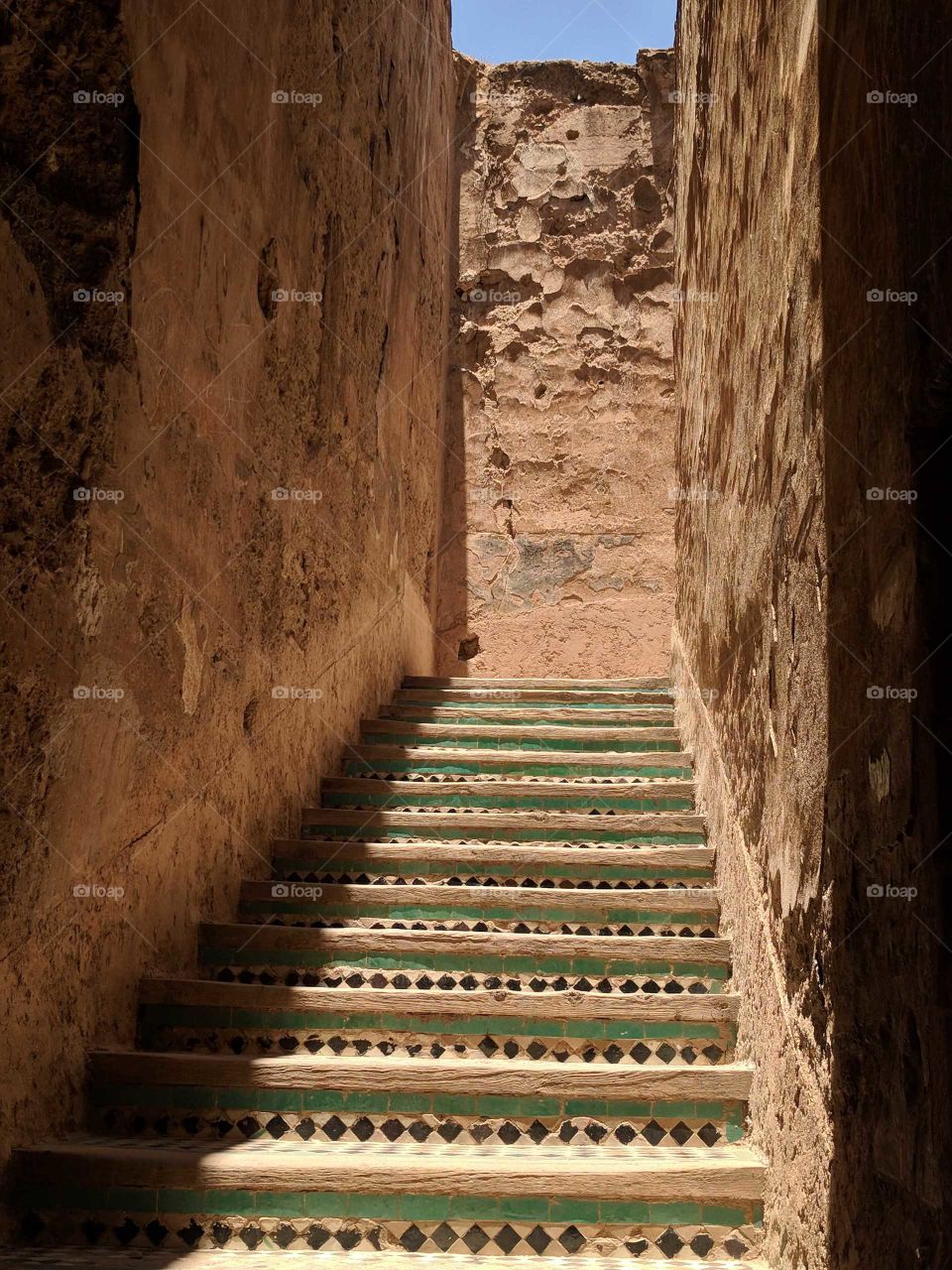 Gorgeous Ceramic Tile Mosaic Staircase Surrounded by Stone Walls and Shadows at the Palais El Badi, an Ancient Palace in Marrakech in Morocco