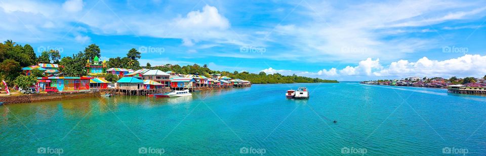 Beautiful view of Rainbow Village in Tual City with a blue bay