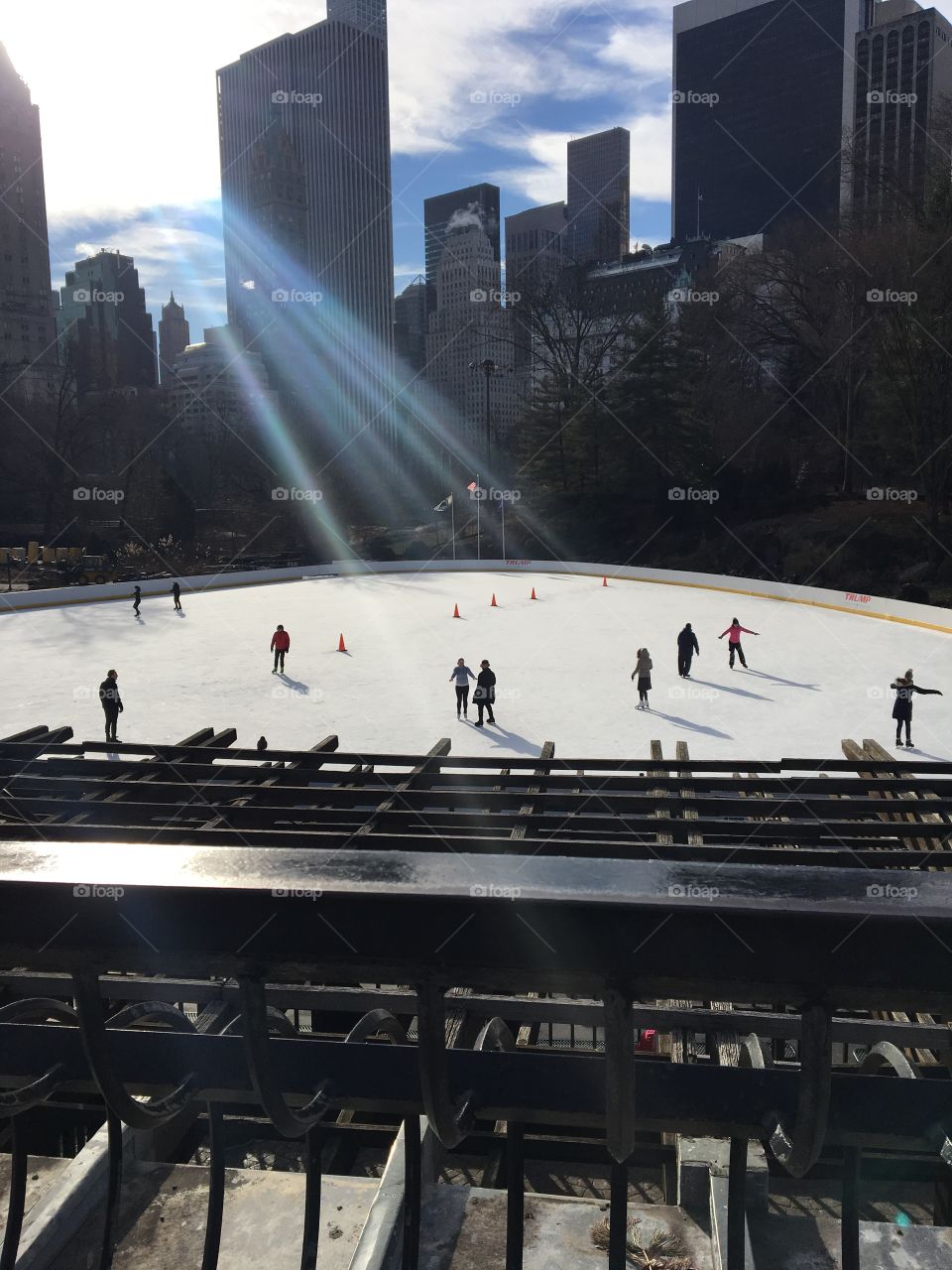 Ice skating rink in Central Park with a beautiful view of the skyscrapers in the city