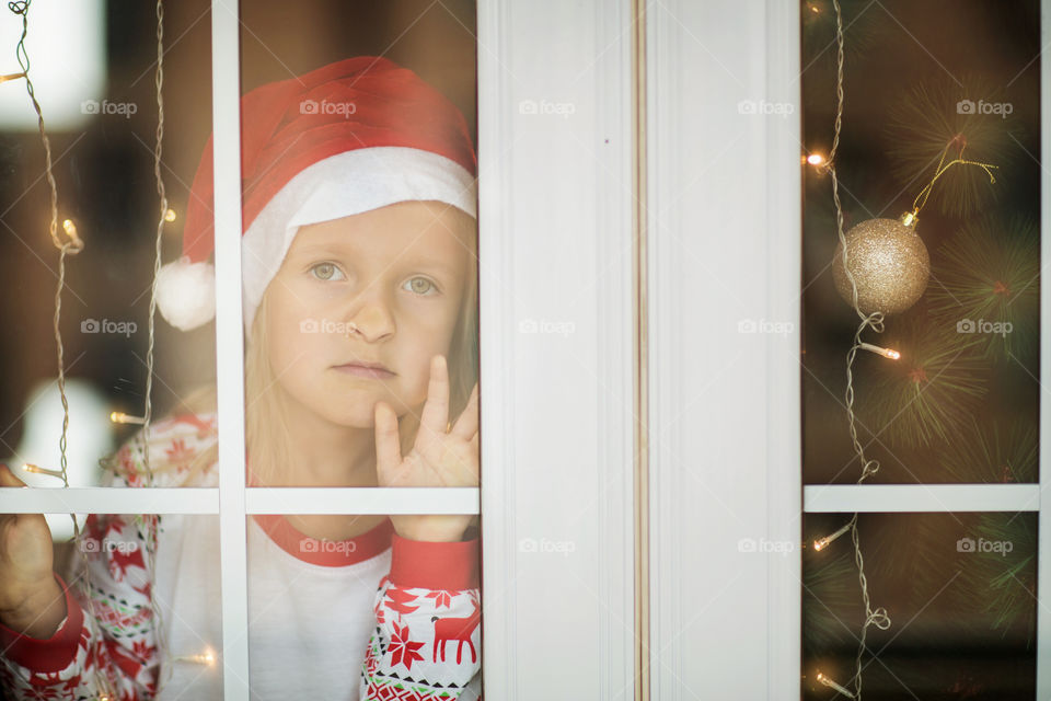Portrait of cute little girl in Christmas pajamas 