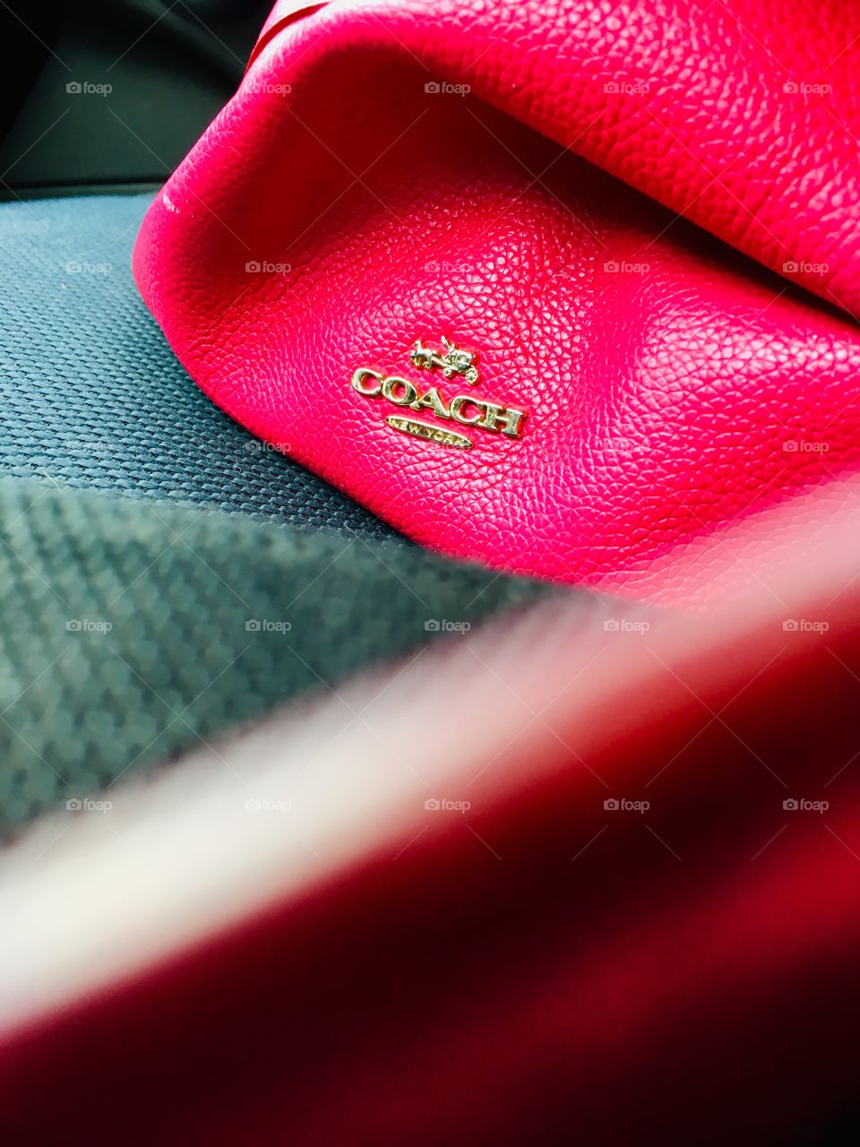 Pink Coach purse sitting on my passenger seat 