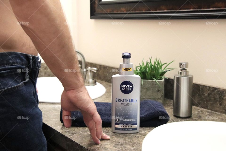 Nivea breathable lotion in bathroom with man
