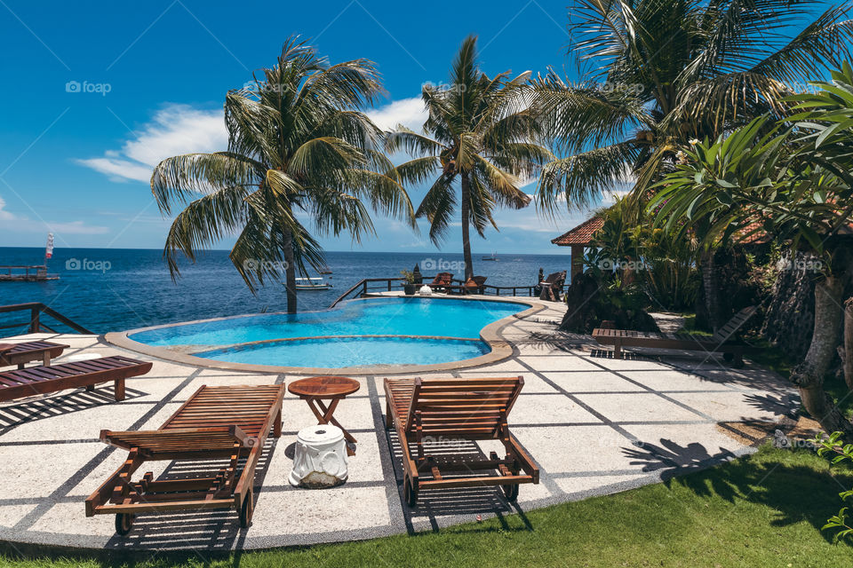 Tropic pool overlooking the Indian Ocean. Bali island, Indonesia.