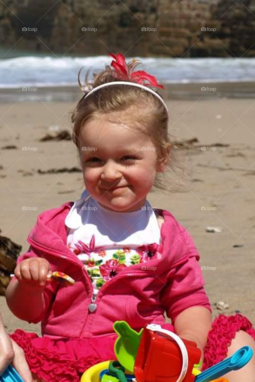 pretty blond toddler on the beach on st ives bay, Cornwall
