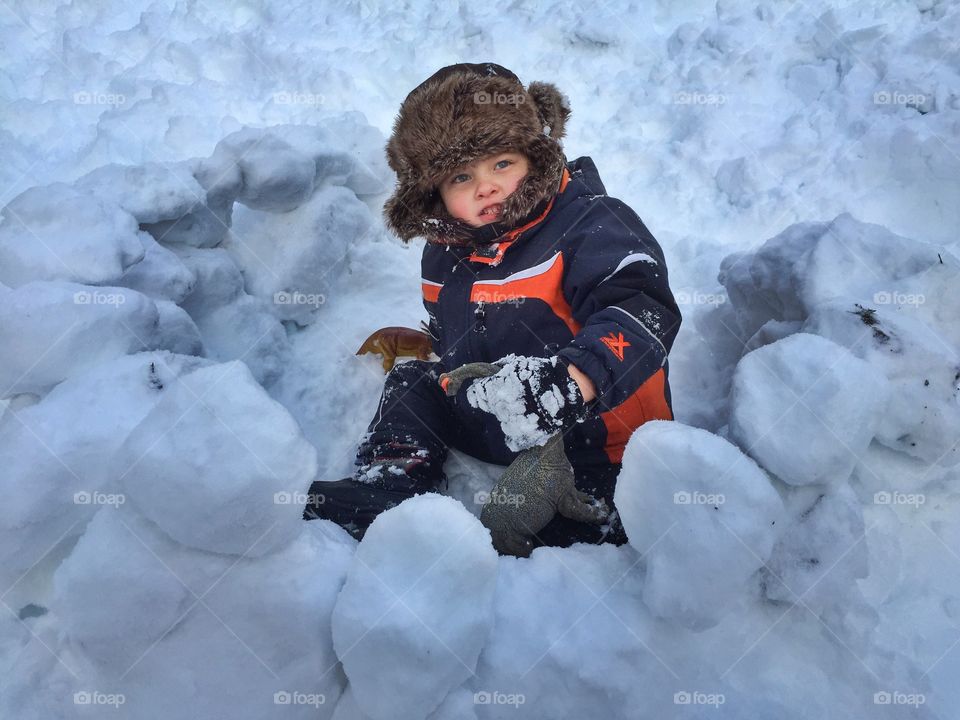 Little boy playing in snow