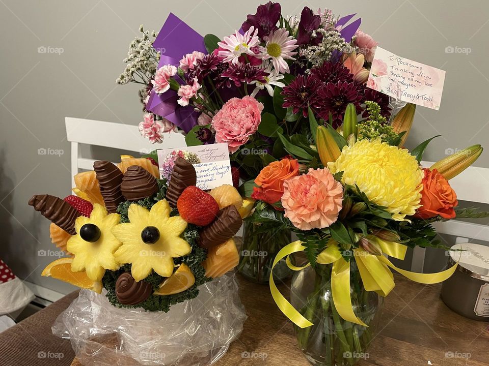 Condolences fruit and flower bouquets in vases, so colourful and bright and got in spring, taken on iPhone 12