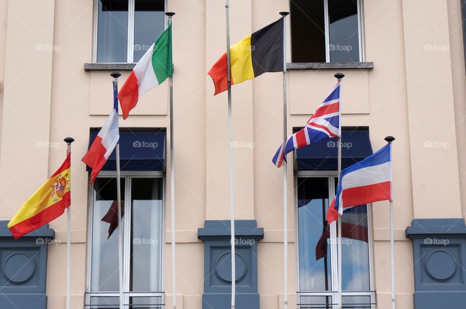 Facade of a hotel with flags.
