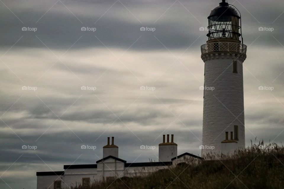 Lighthouse with moody evening clouds