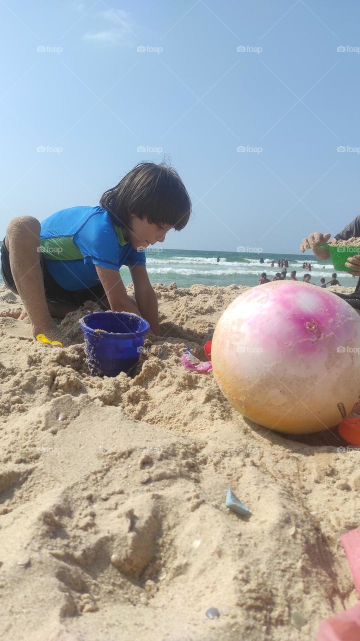 This photo of a child playing on the beach was taken using a mobile camera